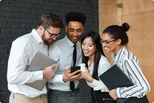 people watching a cell phone among coworkers