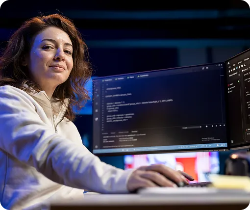 QA professional analyzing code on monitors