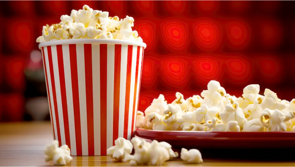 A large bag of popcorn, with white and red stripes