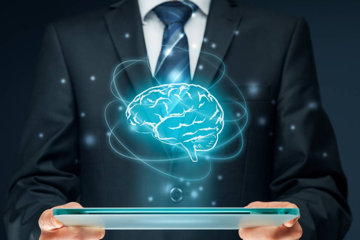 Businessman holding a tablet with a hologram of a brain, symbolizing artificial intelligence and technological innovation.