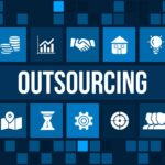 Palavras e ícones destacando "Outsourcing" em um painel digital azul, representando serviços terceirizados.