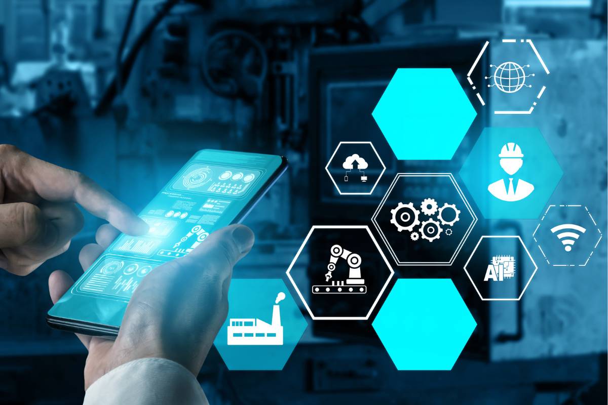 Hands using a smartphone with hexagonal icons representing industrial automation and advanced technology.