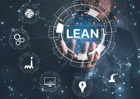 Digital representation of the Lean concept, featuring a hand holding a futuristic hologram with the word "LEAN" prominently displayed. Surrounding it are icons representing various industries and technological processes. The image illustrates the application of Lean’s five principles in corporate environments, highlighting efficiency, innovation, and digital transformation.