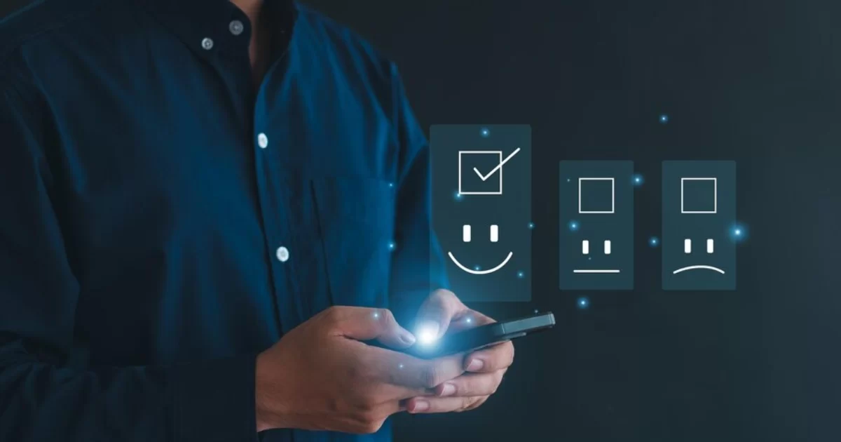 a man with a cellphone showing a happy face representing combing QA with AI.
