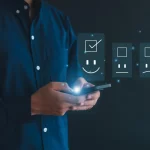 a man with a cellphone showing a happy face representing combing QA with AI.