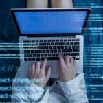 hands writing codes in react and node.js using a laptop