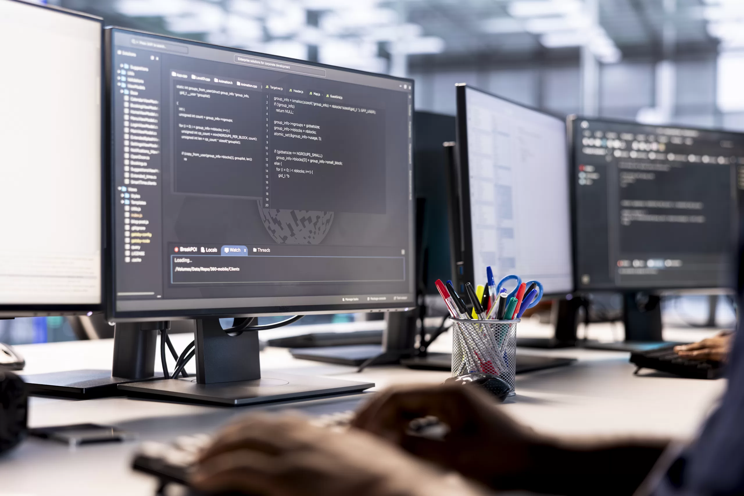 Image of two computers screens showing codes, representing web and mobile development
