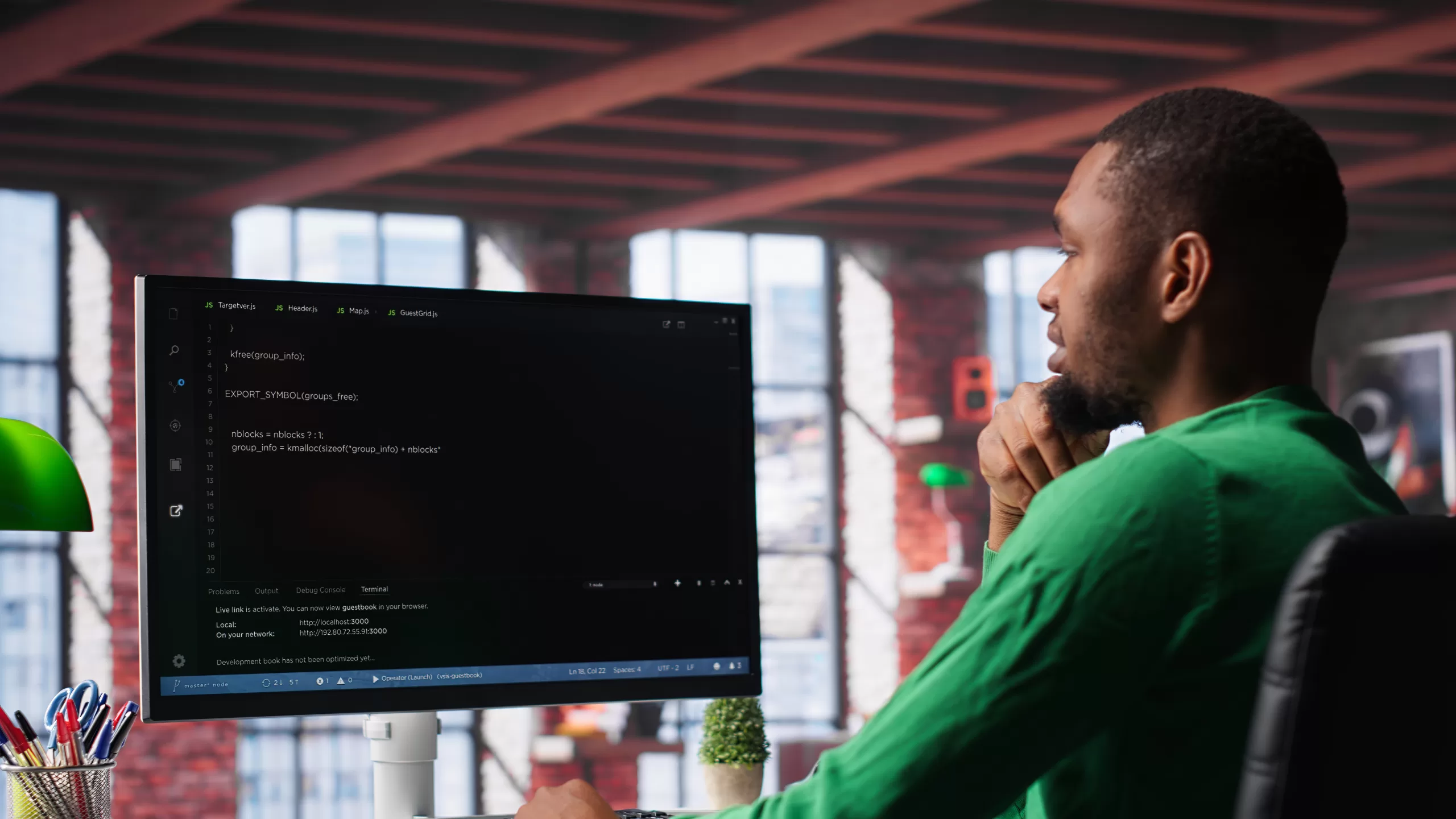 Developer thoughtfully looking at the screen with source code open in a modern, naturally lit workspace.