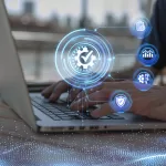 Digital quality control and modernization concept: a gear with a check mark floating over a laptop, symbolizing diagnosis and system optimization.