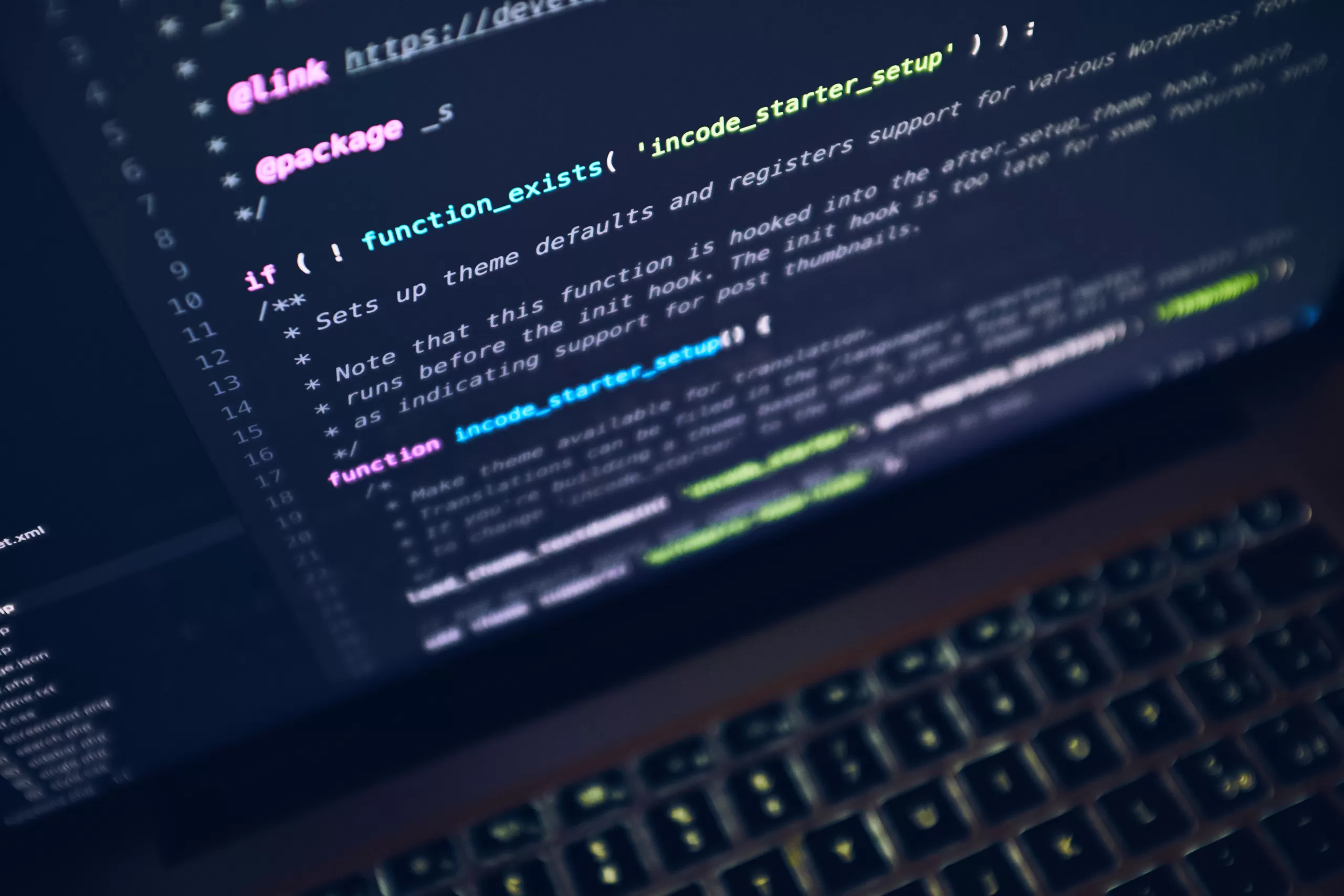 Laptop screen displaying lines of code in an editor, illustrating development work and the complexity of legacy code that might lead to a rewrite.
