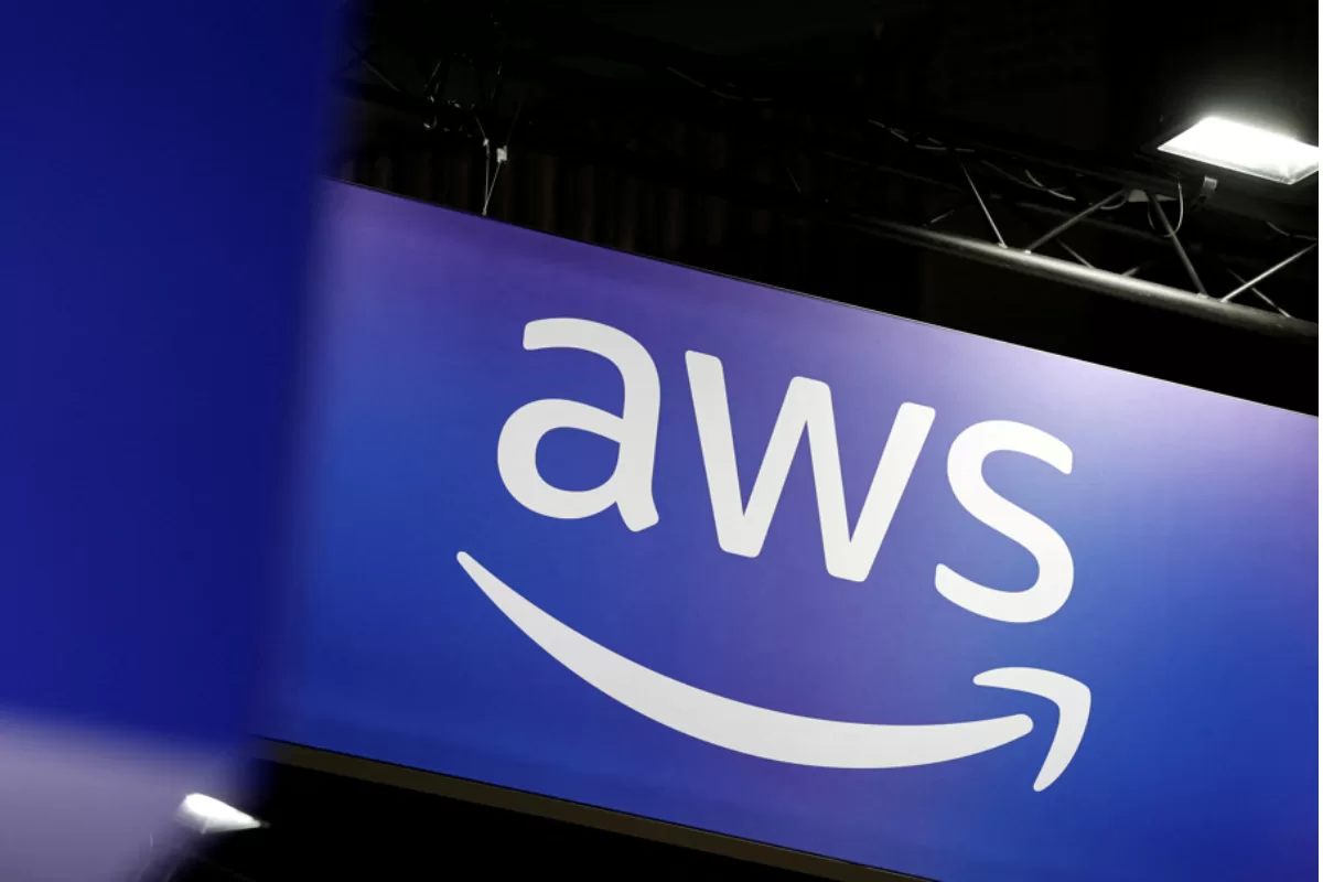AWS (Amazon Web Services) logo on a purple illuminated sign, representing Amazon’s cloud computing platform.