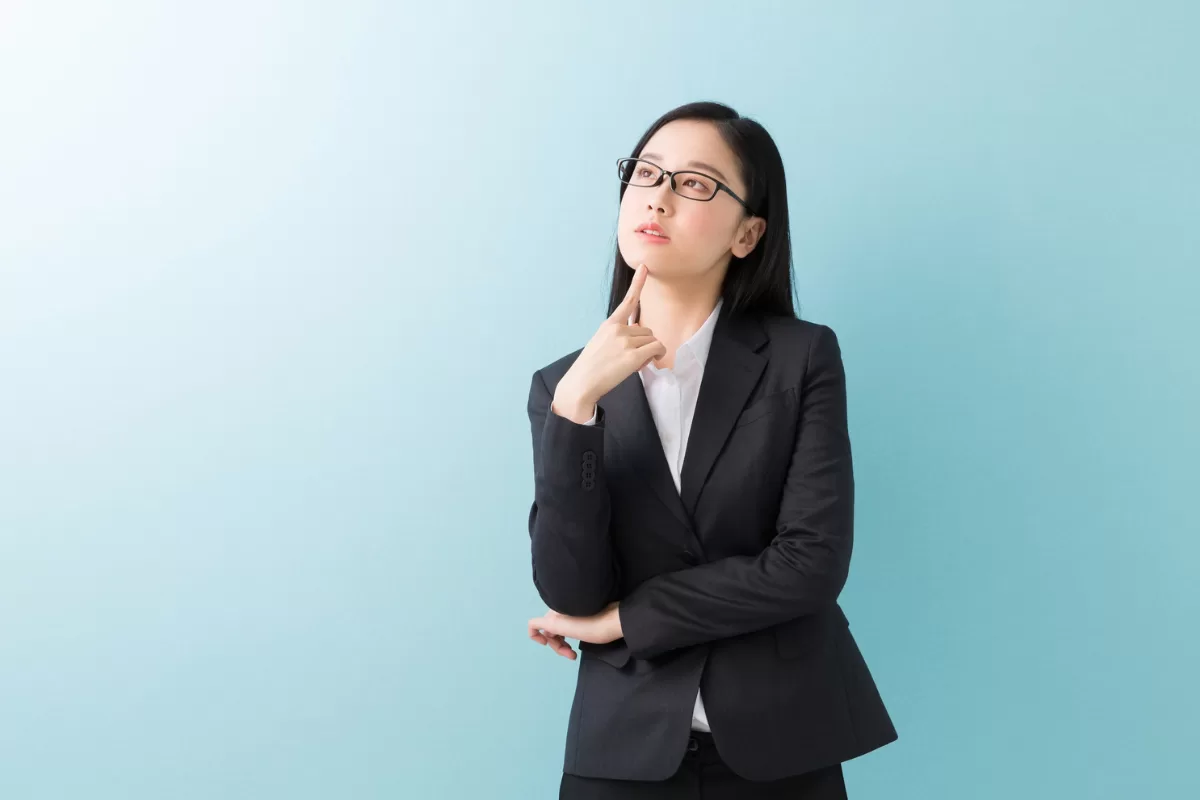 Thoughtful technology professional in business attire, reflecting on career development and IT skills