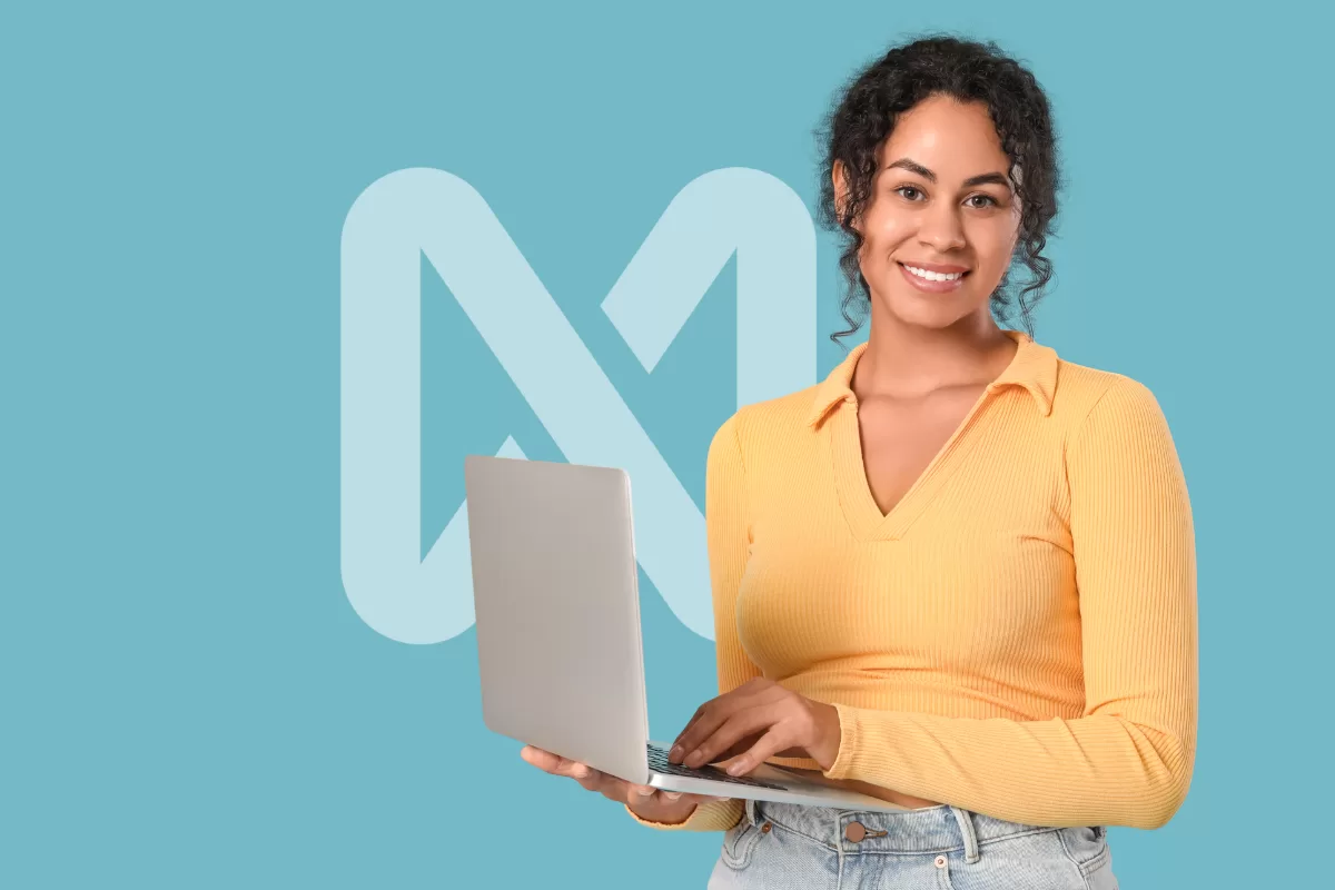 Woman smiling while holding an open laptop in front of a blue background featuring the NextAge logo at the center.