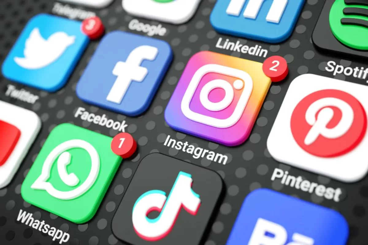 Smartphone app icon grid featuring Twitter, Facebook, Instagram, WhatsApp, TikTok, LinkedIn, Spotify, and Pinterest