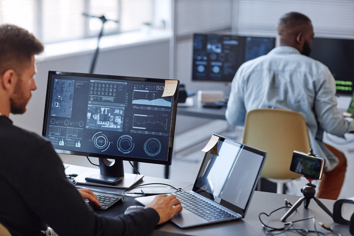 Technology professionals monitoring artificial intelligence dashboards in a corporate environment
