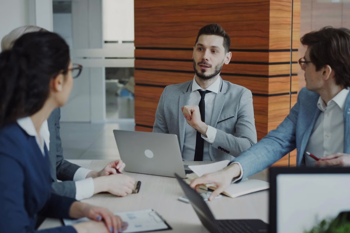 Technology professionals in a meeting discussing squad as a service costs