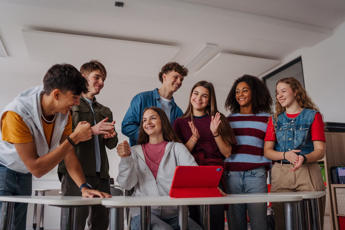 A group of kids using technology at school