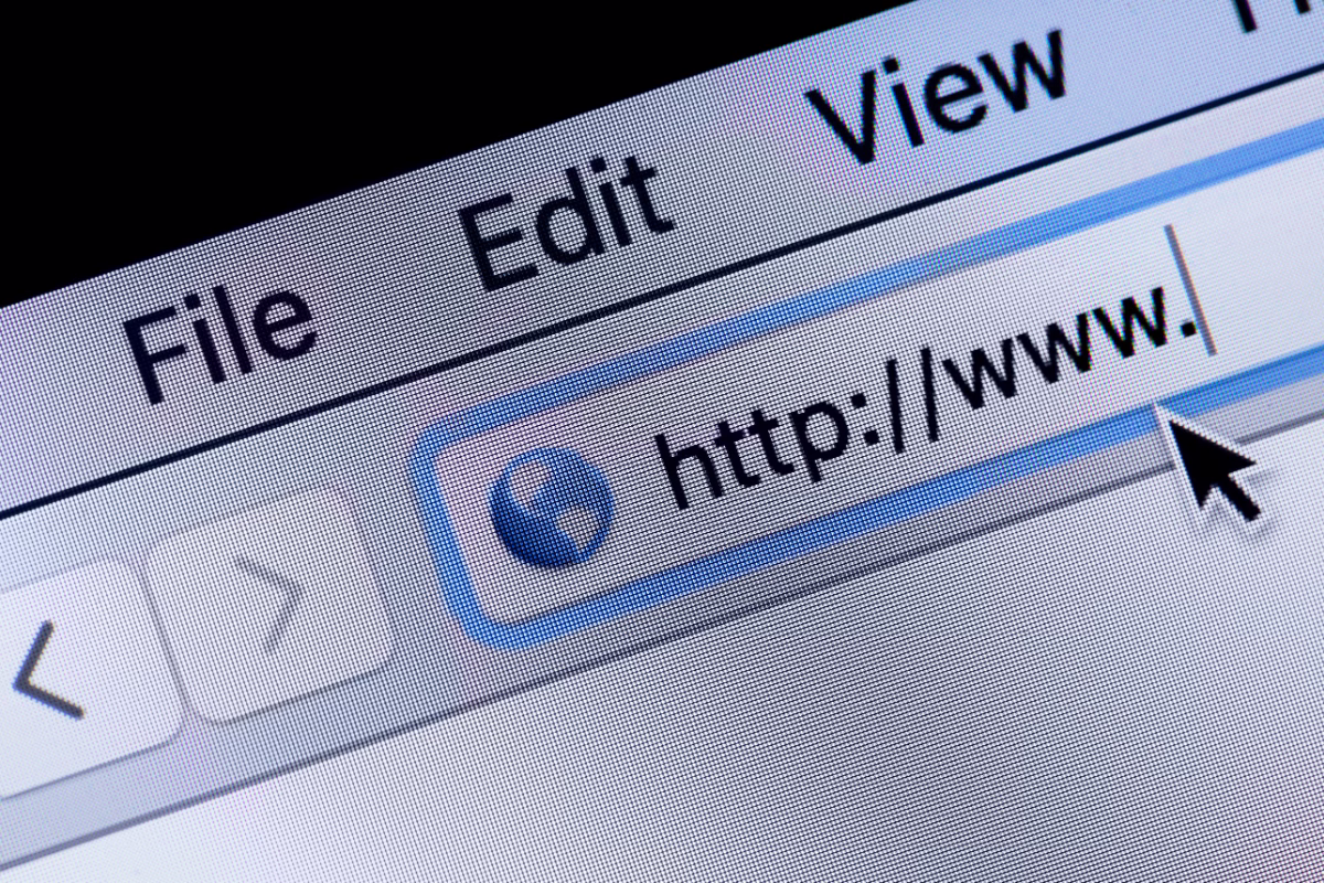 Close-up of a computer monitor screen showing the address bar of a classic or vintage web browser. The black arrow mouse cursor points to the input field displaying the start of a URL with "http://www. ", showing visible screen pixels and the top menu bar with File, Edit, and View options.