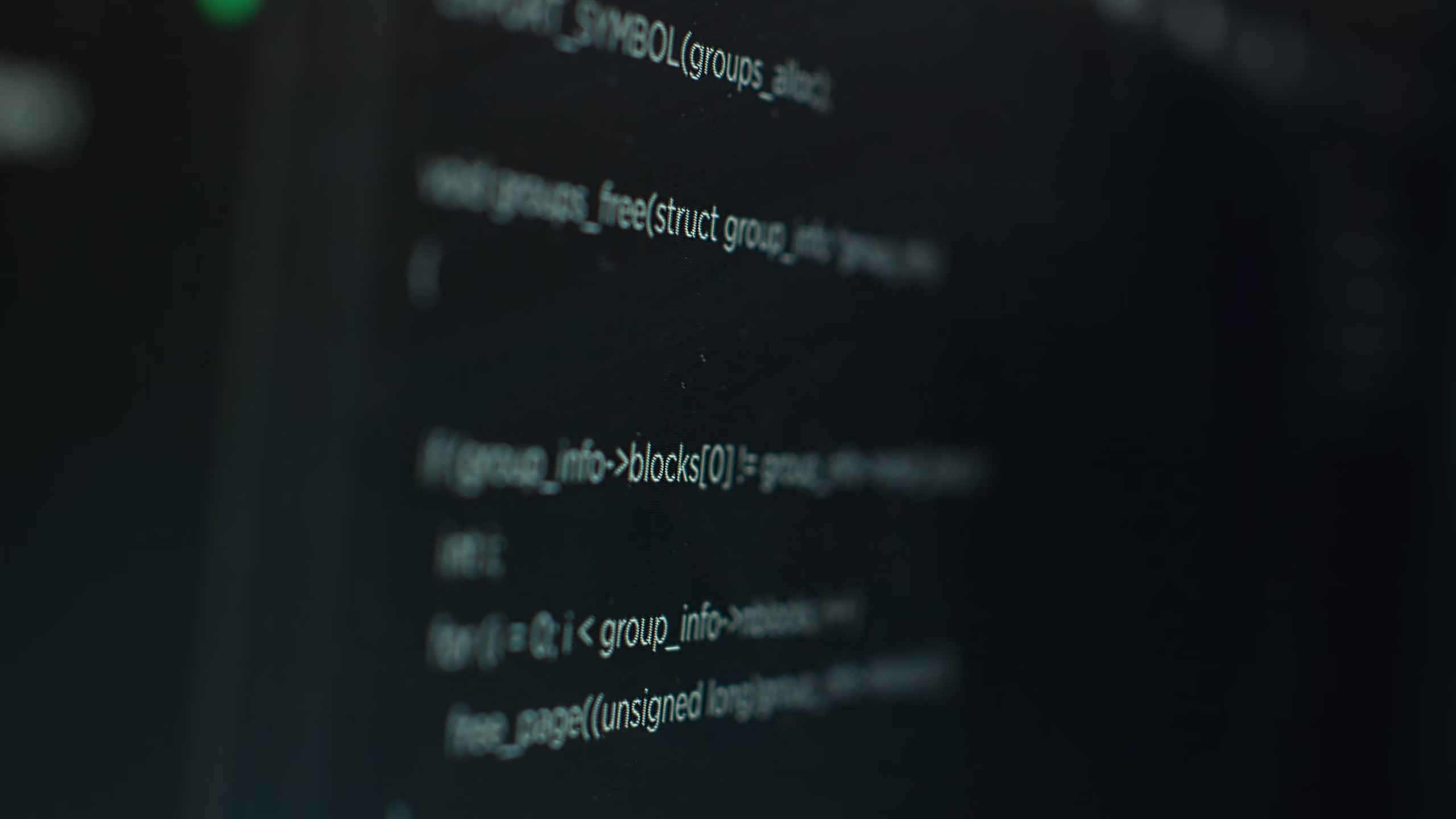 Close-up of a dark screen showing lines of source code in light text, with shallow depth of field, illustrating an article about what C# is.